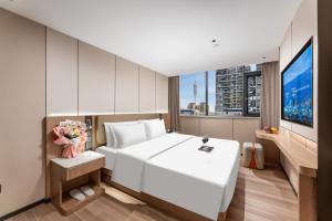 Postel nebo postele na pokoji v ubytování Guangzhou JinTang Hotel + 37 fotografií