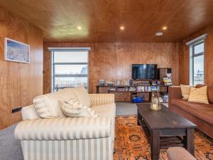 a living room with a couch and a table at Mountain Haus - Ohakune Holiday Home in Ohakune