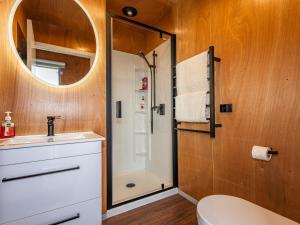a bathroom with a shower and a sink and a mirror at Mountain Haus - Ohakune Holiday Home in Ohakune +18 photos