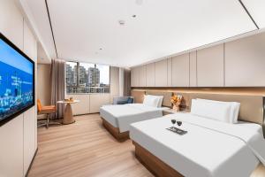 TV a/nebo společenská místnost v ubytování Guangzhou JinTang Hotel