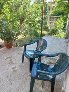 a blue chair sitting on top of a patio at Cozy Riverside Apartment in Këlcyrë