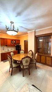 a dining room with a table and chairs in a kitchen at apartement cempaka mas in Jakarta
