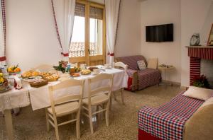 a dining room with a table with food on it at B&B Aria Ona in Villagrande Strisaili