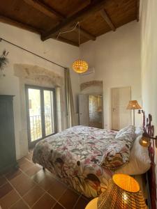 a bedroom with a bed and a large window at Mater Familias Oasis in Syracuse