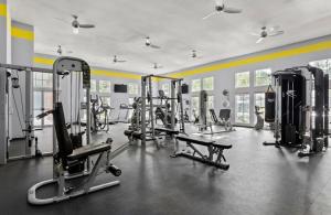 a gym with several exercise equipment in a room at Apartment in Houston near NRG with Free Parking in Houston