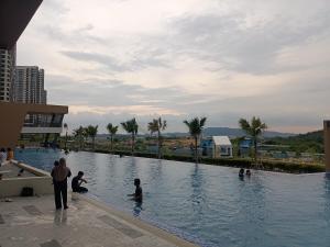 a group of people sitting in a swimming pool at Jedi Homestay in Kajang