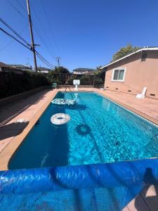 a swimming pool with blue water in front of a house at Relax at 4Bedrooms retreat nearby Apple in Santa Clara