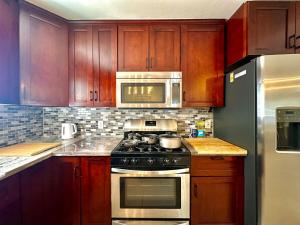 a kitchen with a stove and a microwave at Intern Choice Cozy 2B2B House nearby Apple Park in Santa Clara
