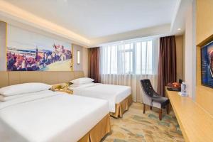 Un pat sau paturi într-o cameră la Vienna Hotel Nanning Beihu Metro Station +102 fotografii