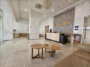 a lobby with a desk and a table in a building at Skyhouse bsd tower duxton 2 in Samporo +10 photos