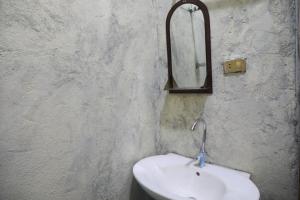 a bathroom with a sink and a mirror on the wall at Amazing Lalibela Home stay in Lalibela +56 photos