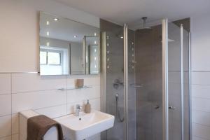 a bathroom with a sink and a shower at Gut Kuhfs in Großzössen +78 photos