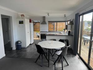 a kitchen with a table and chairs in a room at Bircoo Cottage in Bridport +13 photos