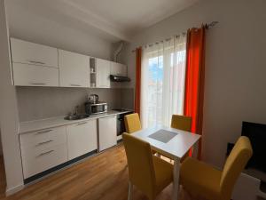 a kitchen and dining room with a table and chairs at Apartment DORA in Cetinje