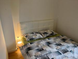 a bedroom with a bed with two pillows at Apartment DORA in Cetinje