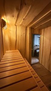 a room with a bed in a wooden room at Rama House in Liepāja