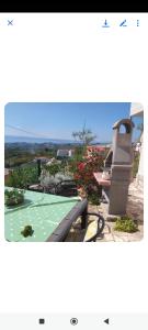 a view of a garden with a bench and flowers at Cosy apartman Split - in green area in Solin