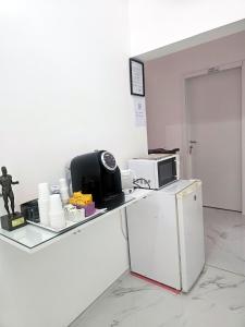 a kitchen with a counter with a microwave and a refrigerator at Relax ON 247 in Rome