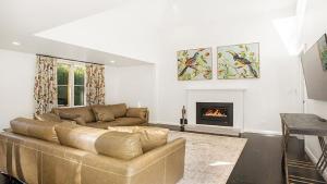 a living room with a couch and a fireplace at Glenluce Mountain Cottage Circa 1896 in Wentworth Falls