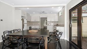 a kitchen and dining room with a table and chairs at Glenluce Mountain Cottage Circa 1896 in Wentworth Falls