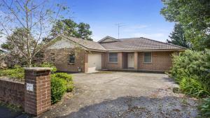 a brick house with a driveway at Refresham Katoomba South in Katoomba