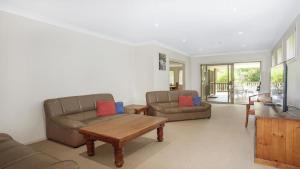 a living room with two couches and a coffee table at Refresham Katoomba South in Katoomba