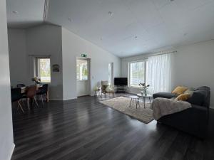 a living room with a couch and a table at Anolanranta Beach House - Golf & Lake in Pieksamaki