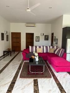 a living room with a pink couch and a table at Hua Hin in Hua Hin +67 photos