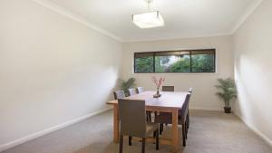 a dining room with a table and chairs at The Cherry Blossom Blackheath in Blackheath