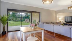 a living room with a couch and a table at The Cherry Blossom Blackheath in Blackheath