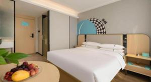 Postel nebo postele na pokoji v ubytování City Comfort Inn Nanning Guangxi University