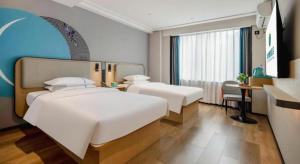 Postel nebo postele na pokoji v ubytování City Comfort Inn Nanning Guangxi University