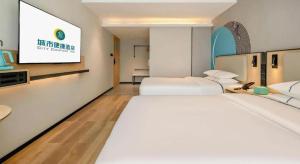 Postel nebo postele na pokoji v ubytování City Comfort Inn Nanning Guangxi University