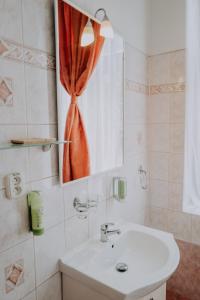 a bathroom with a sink and a mirror at The Rooms by Dalia in Košice
