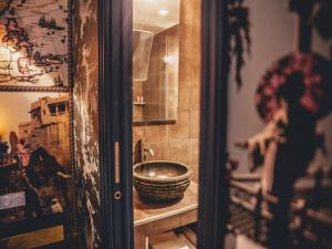 a bathroom with a sink and a bowl on a shelf at Hôtel du Continent in Paris +71 photos