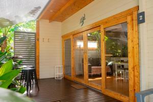 a screened in porch with sliding glass doors at Kapok Pod entire studio in Horseshoe Bay