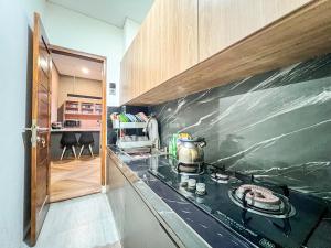 a kitchen with a counter with a tea kettle on it at Sewon Regency Homestay Jogja in Gandok
