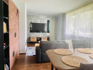 a living room with a couch and a table at Cozy Family House with Sauna & Garden in Kärdla