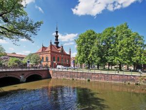 a bridge over a river in front of a building at Gold Box Apartament in Gdańsk