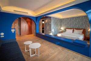 A bed or beds in a room at Ramada Loutraki Poseidon Resort