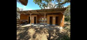 a small house with a roof on a dirt field at Le Tipi in Lecci
