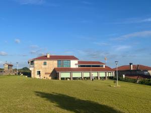 a large building with a grass field in front of it at A Casa do Pillado in Golada