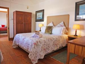 a child laying on a bed in a bedroom at Grazia Cottages in Port Nolloth +7 photos