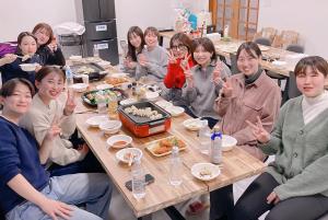 un gruppo di persone sedute attorno a un tavolo che mangiano cibo di 貸切宿さうなす a Nasushiobara