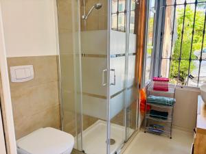 a shower stall in a bathroom with a toilet at Friendly Africa Room Como Center in Como