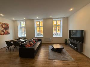 a living room with a couch and a flat screen tv at Lilly apartments in Bratislava