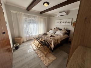 a bedroom with a bed and a window at Shamba Self-Catering in Pretoria +24 photos