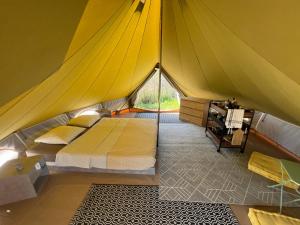 a bedroom in a tent with a bed in it at Le Tipi in Lecci