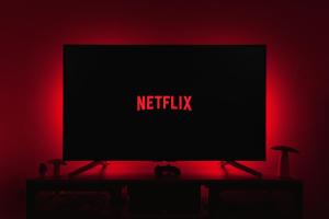 a flat screen tv sitting on a table in a red room at Comfort Central Point apartment in Podgorica