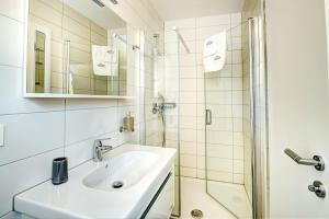 a bathroom with a sink and a shower at Cool Šilo Appartement Resort in Šilo